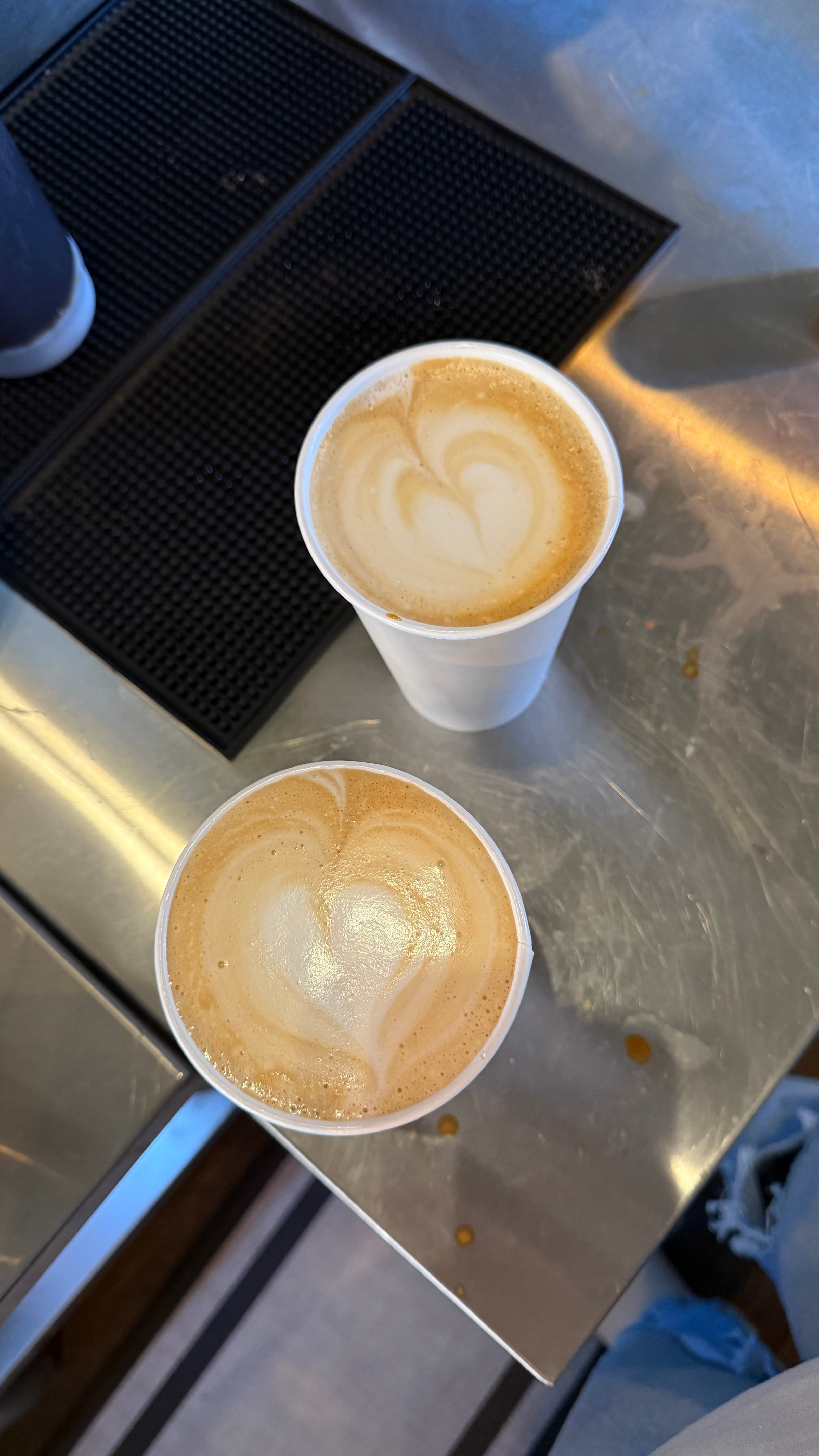 Two hot lattes with heart foam art